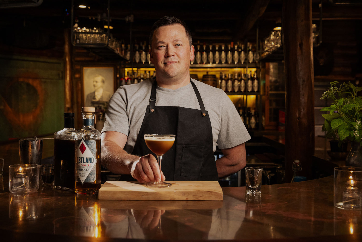 Bartender standing behind cocktail