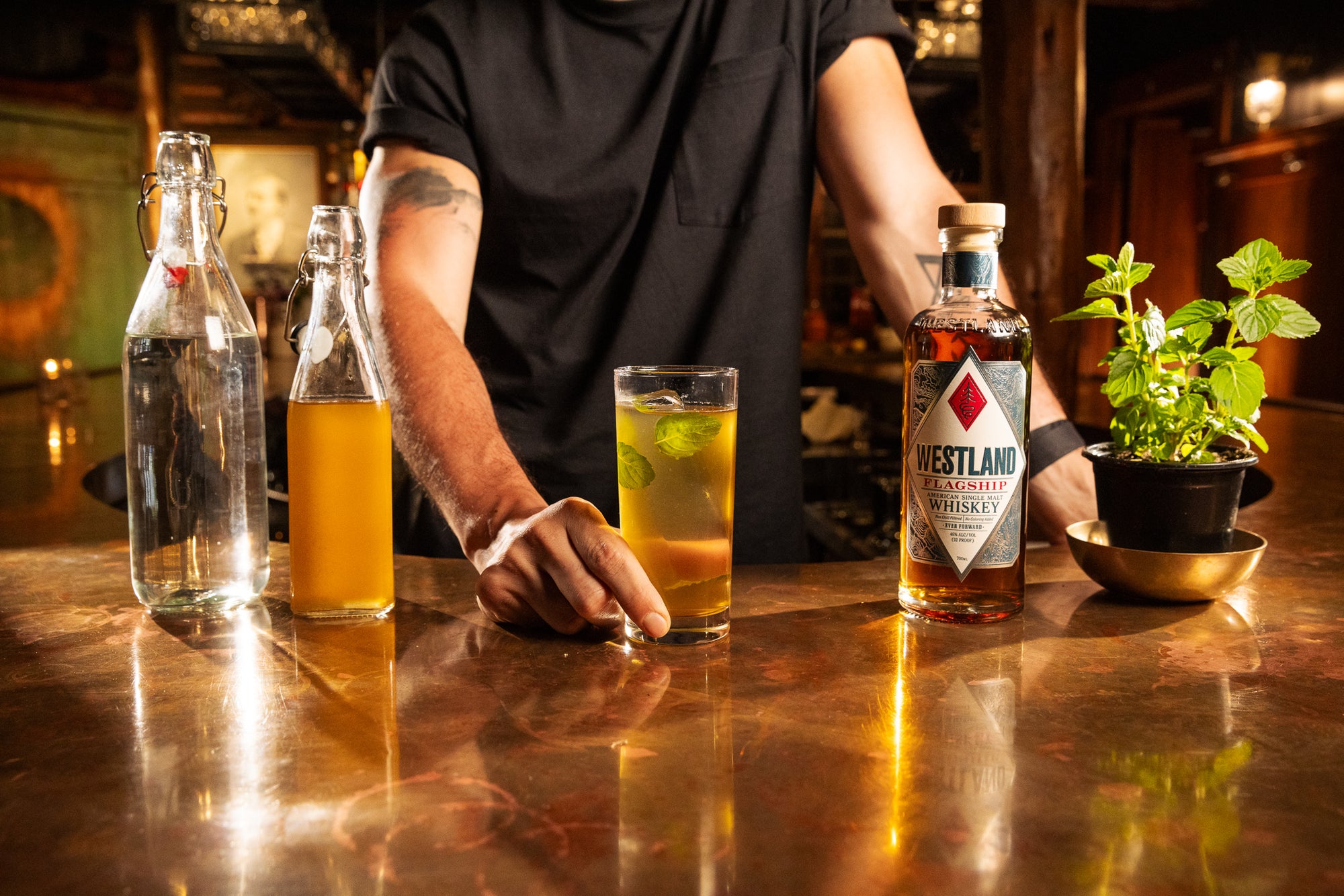 Man at a bar holding a cocktail